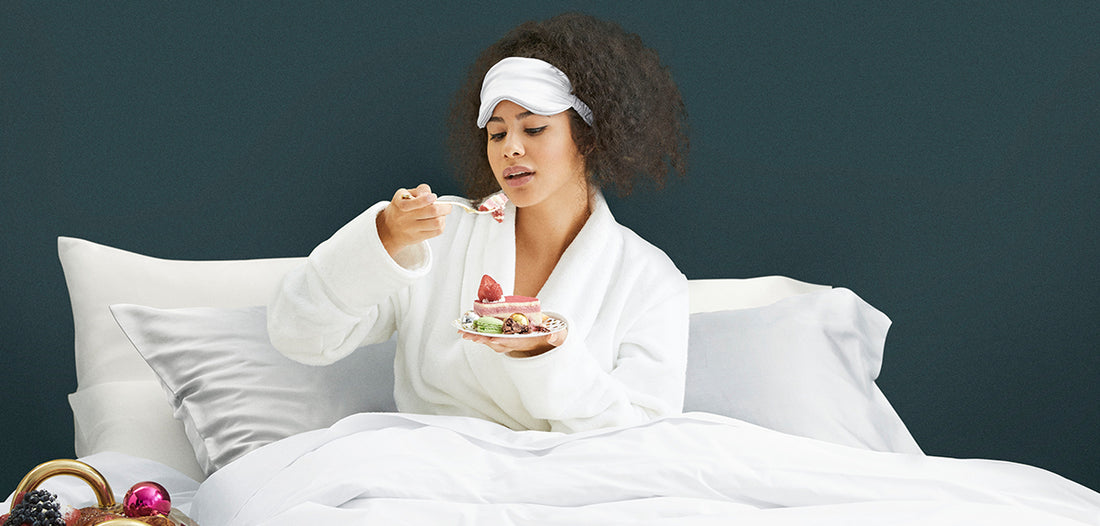      | Woman in bed eating dessert on silk pillowcases