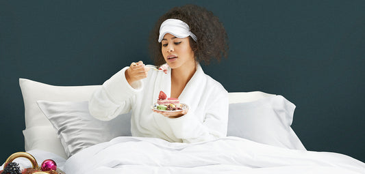      | Woman in bed eating dessert on silk pillowcases